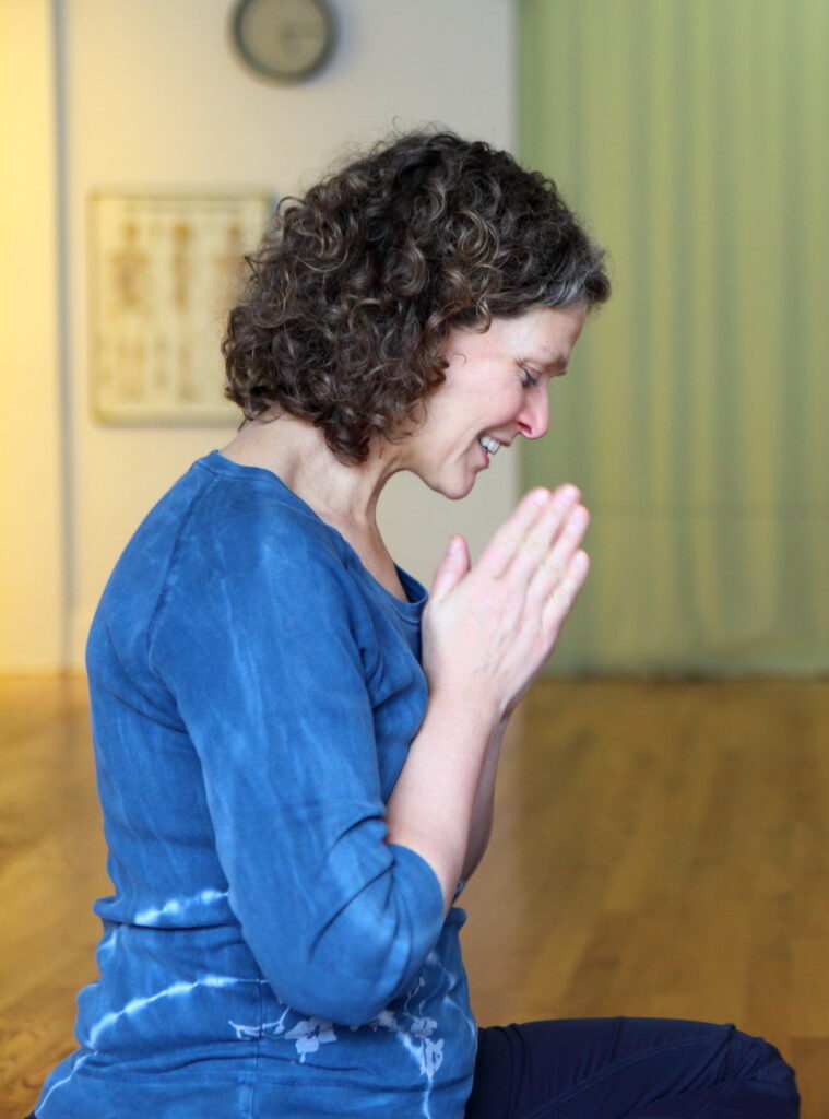 Corinne Peterson adopts a grateful pose in a simple room filled with light